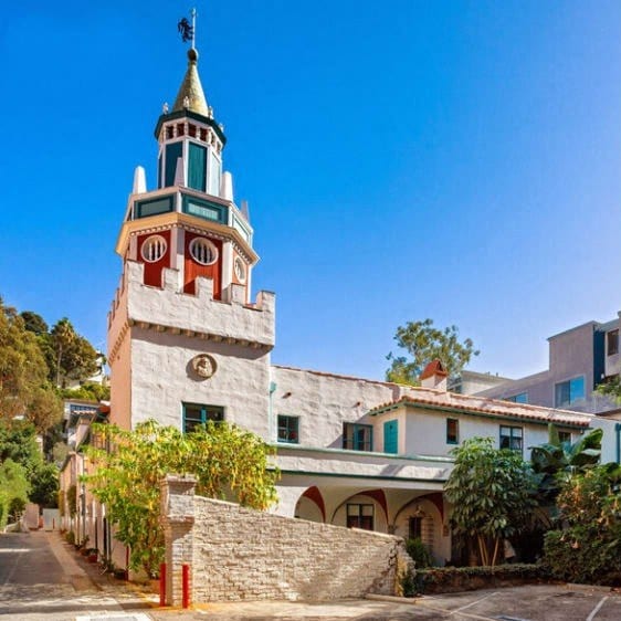 a white building with a clock tower on top of it