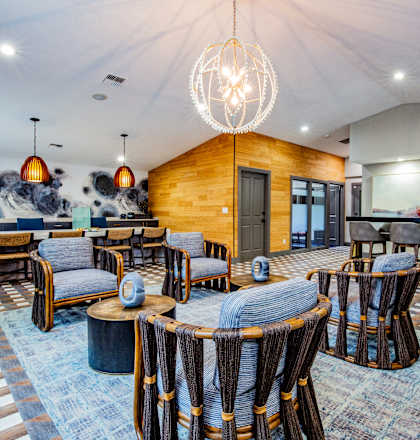 A modern interior with a wooden wall and a large chandelier.