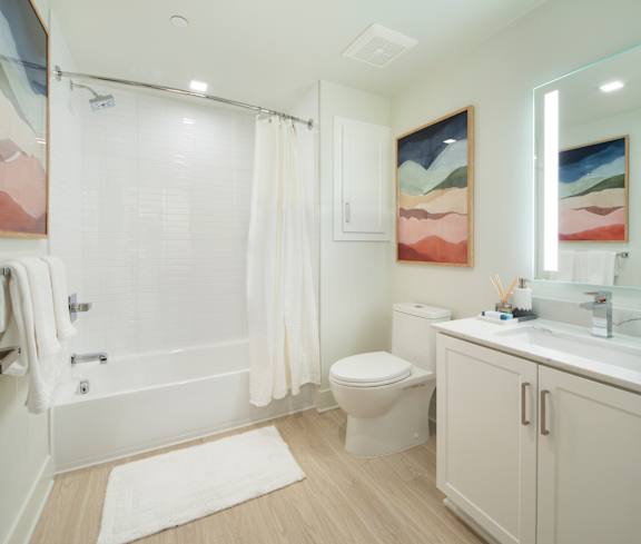 A bathroom with a toilet, sink, and shower.
