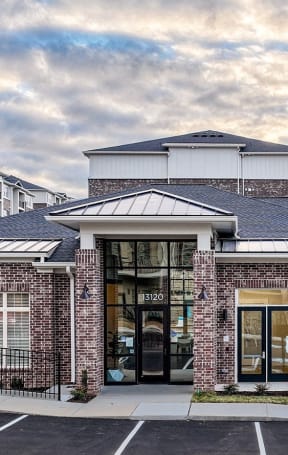 the front of a brick building with a glass door