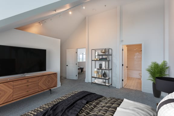 a bedroom with a bed and a tv in a room with a bathroom at Vendome Place, San Jose, CA
