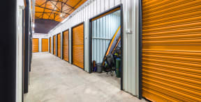 a row of yellow storage doors in a building