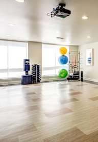 A room with a white screen and a wooden floor.