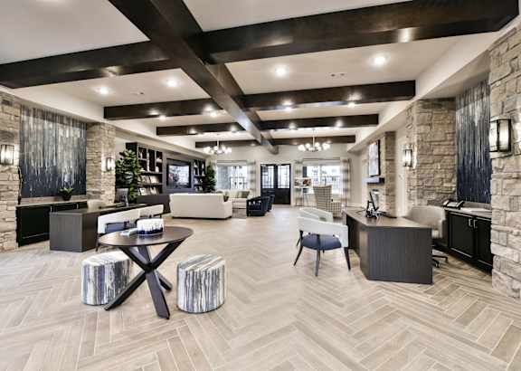 A spacious living room with a stone fireplace and a large wooden table.