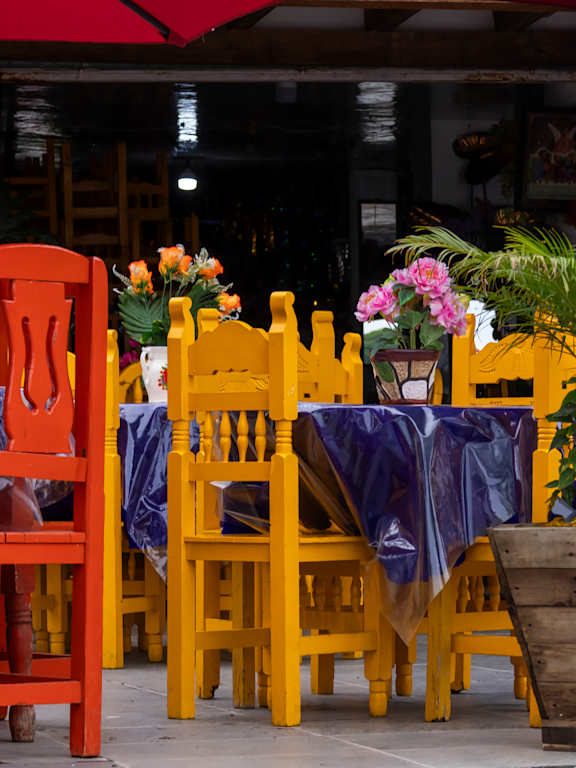 A red chair sits next to a yellow chair.