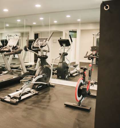 a row of exercise bikes in a gym