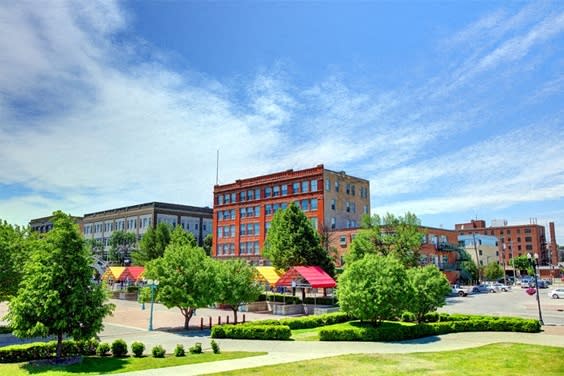 a view of a city street with buildings and trees