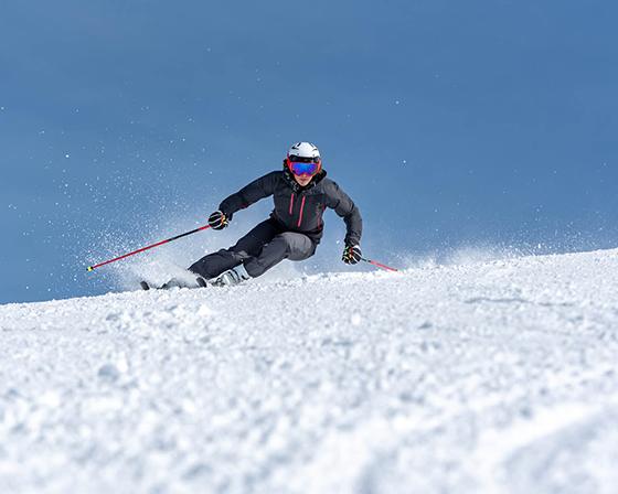 A skier is racing down a snowy slope.
