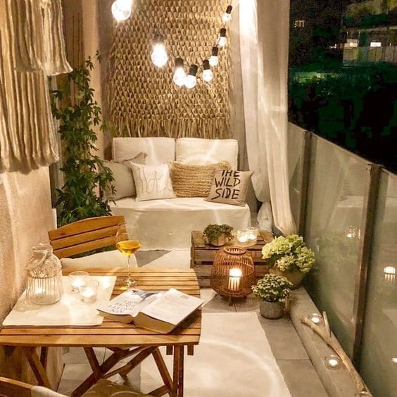 a small balcony with a table and chairs