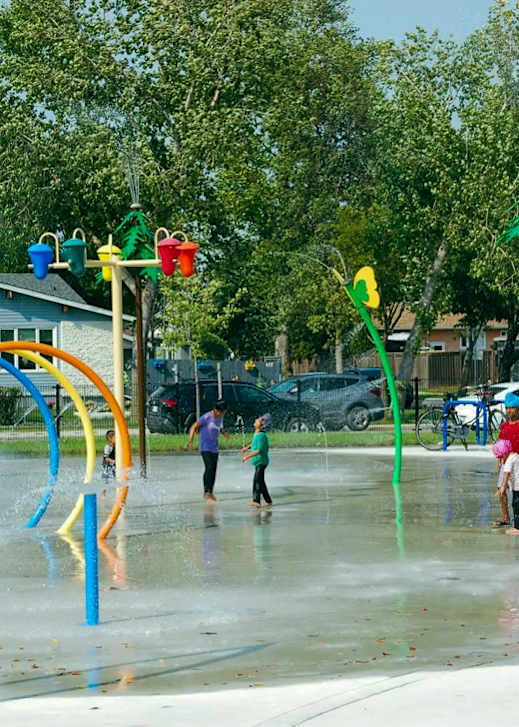 A water playground with children playing in it.