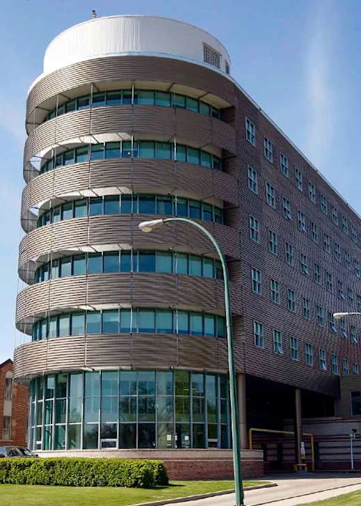 A modern building with a curved design and large windows.