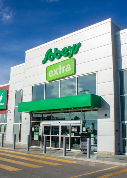 The Sobey's Extra store has a green awning and glass doors.