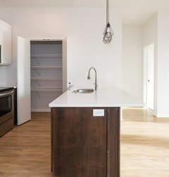 A kitchen with white quartz countertops and white walls at Mercantile on Broadway, Fargo, ND, 58102