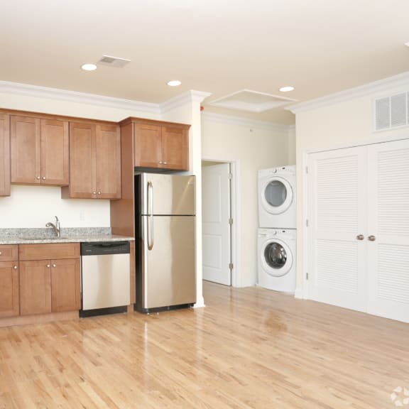 a kitchen with wooden cabinets and stainless steel appliances at Greenway Village Apartments, Metuchen, New Jersey