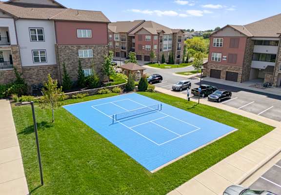 Aerial view of blue tennis court at The Residences at Bluhawk Apartments, Overland Park,