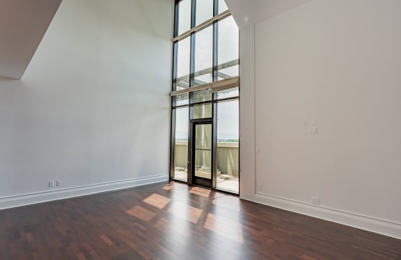 an empty living room with hardwood floors and a large glass door at Vendome Place, San Jose, California