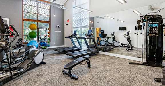 the gym with treadmills and weights at the belgard apartments