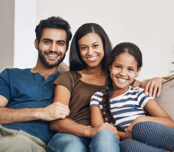 a family sitting on a couch