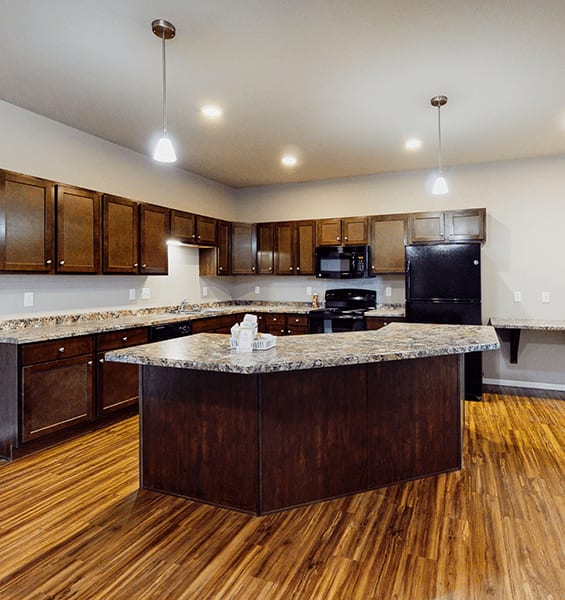 A kitchen with a large island in the middle.