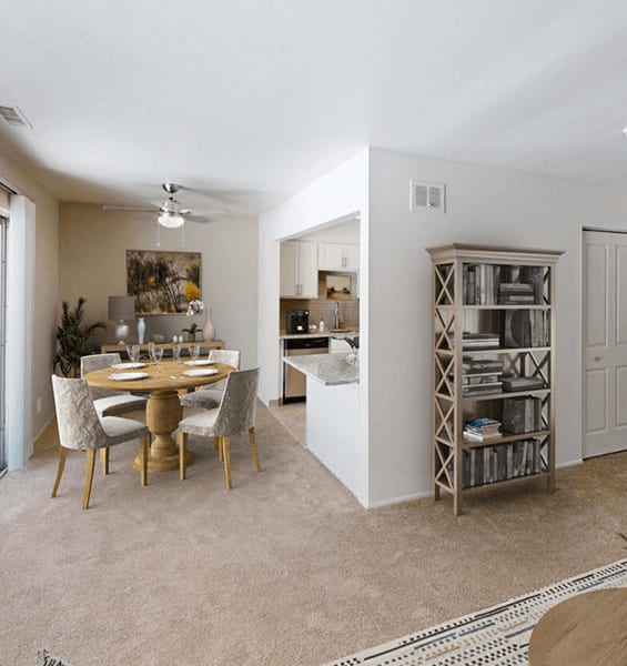 A dining room with a round table and chairs.
