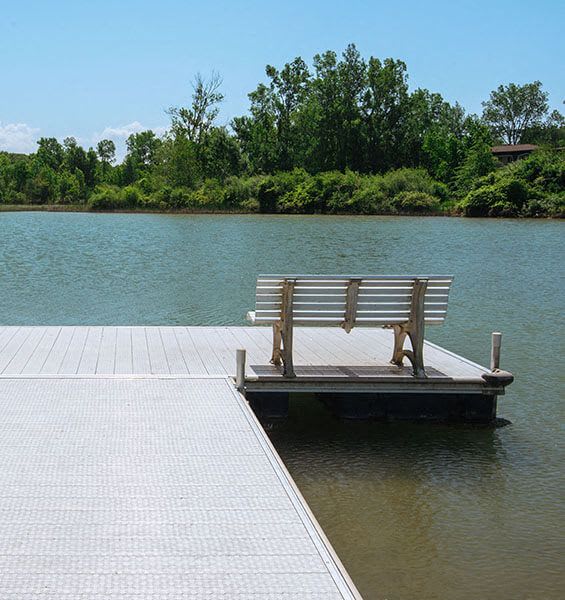 a bench sitting on a dock on the water