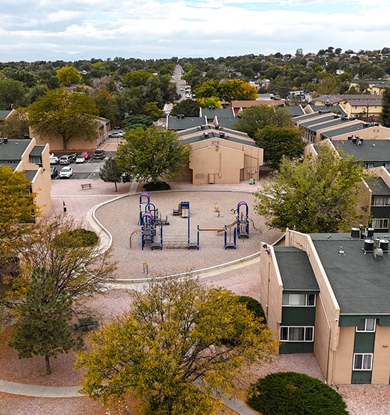 an aerial view of a playground in a residential neighborhood