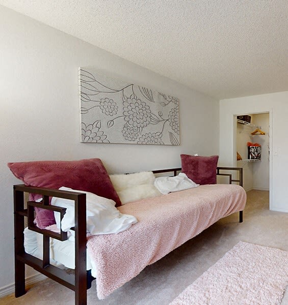 a bedroom with a bed and a painting on the wall