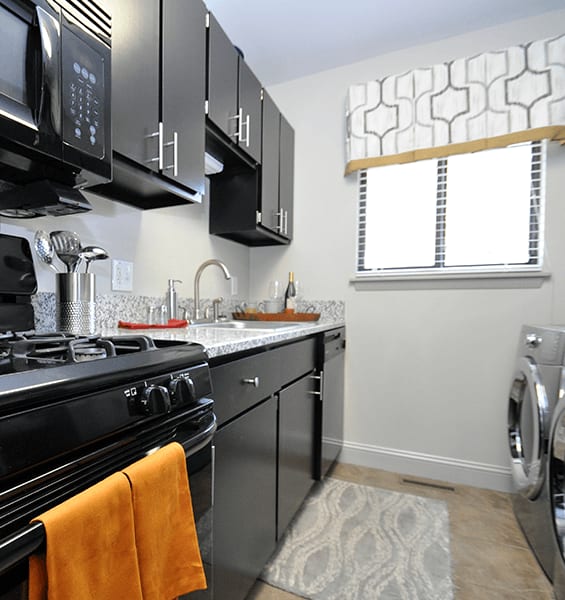 Kitchen with black cabinets and new appliances