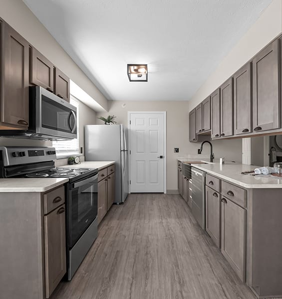 a kitchen with stainless steel appliances and wooden cabinets