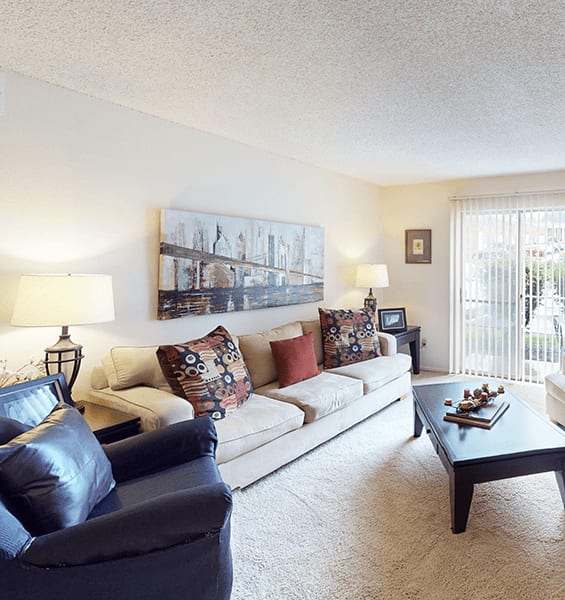 A living room with a couch, chair, and coffee table.