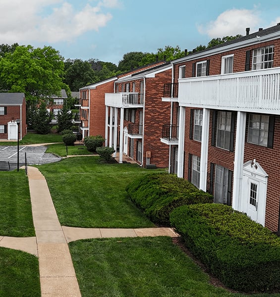 A grassy area in front of apartment buildings.