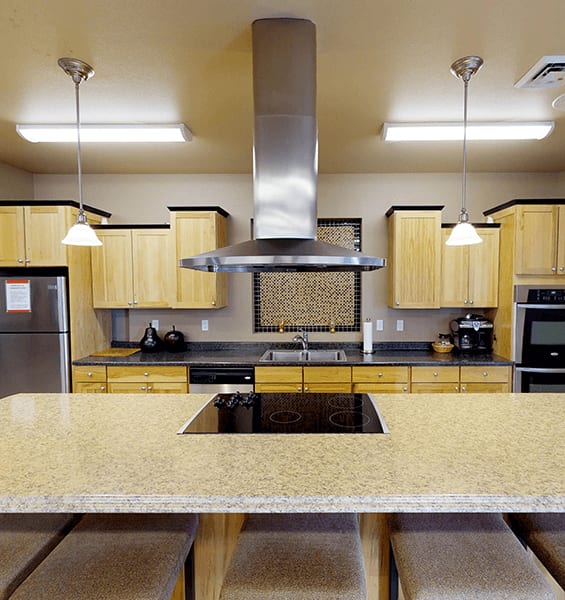a kitchen with a large island and a stove top oven