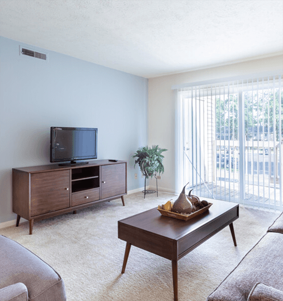 a bedroom with a ceiling fan and a bed with a blue and white comforter