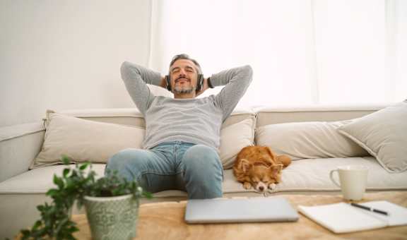 a man and his dog are sitting on the couch with their heads in their hands