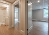 Thumbnail 3 of 7 - A room with a white door and a window.