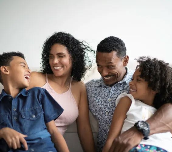 a family sitting on a couch