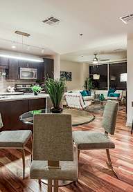 a kitchen and living room with a table and chairs