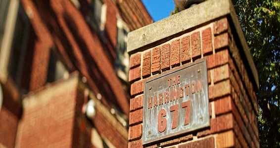 A sign on a brick wall that says "The Washington 677".