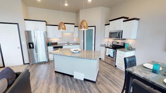 kitchen with island, pantry, copper light fixtures