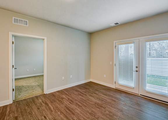 A kitchen with wooden floors and stainless steel appliances.at Hawthorne Pointe, Bondurant, 50035