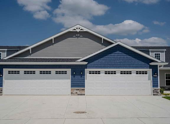 a blue and white house with a garage door