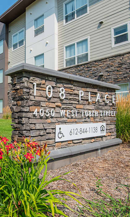 A building with a sign that says 108 Place on it.