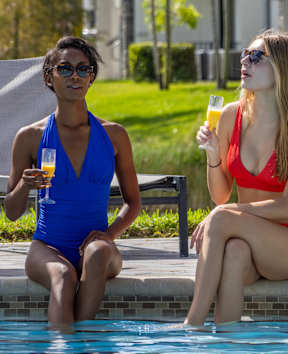 Two woman sitting in bikini near the pool at Portofino Vineyards, Fort Myers, FL