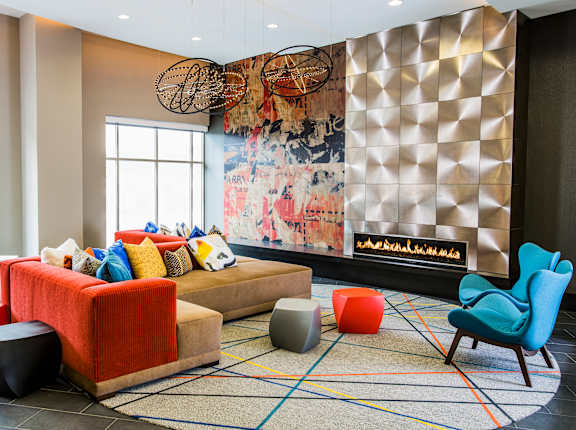 A living room with a large painting on the wall and a fireplace.