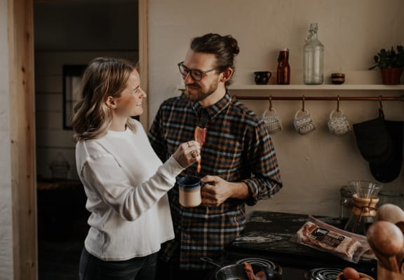 a man and a woman standing in a kitchen