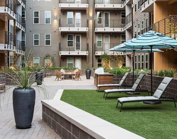 Discovery at the Realm Apartments Outdoor lounge with lounge chairs 