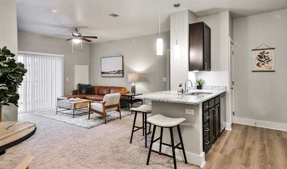 A modern kitchen with a bar stool and a countertop.