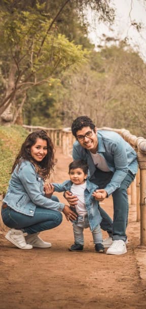 a family posing for a picture with a small child