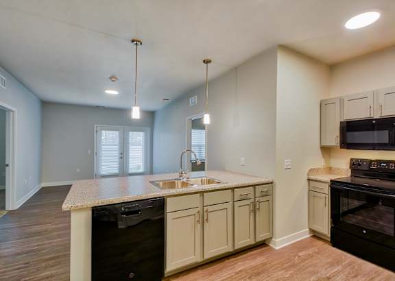A room with a ceiling fan and wooden flooring.at Hawthorne Pointe, Bondurant, 50035