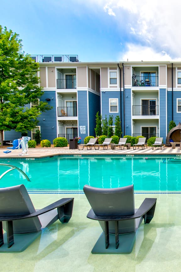 a swimming pool in front of an apartment building